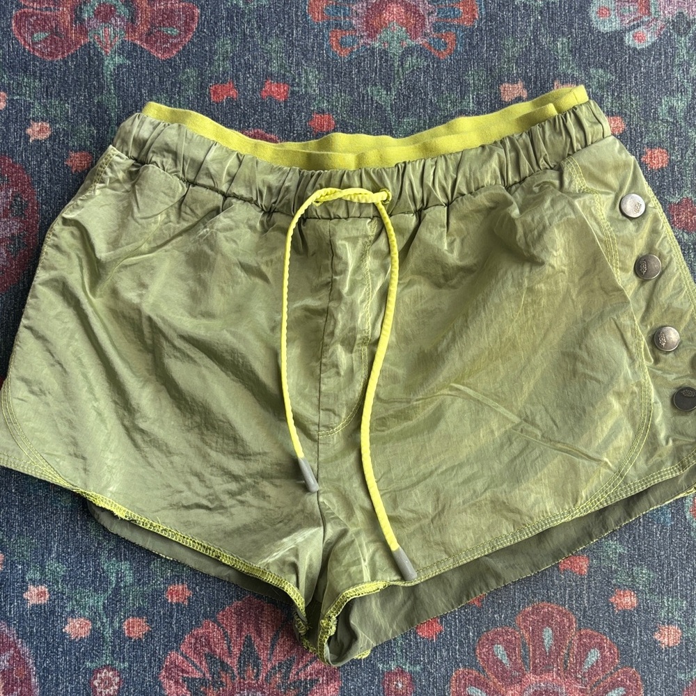 FP Movement olive green running/active shorts with snaps on sides.